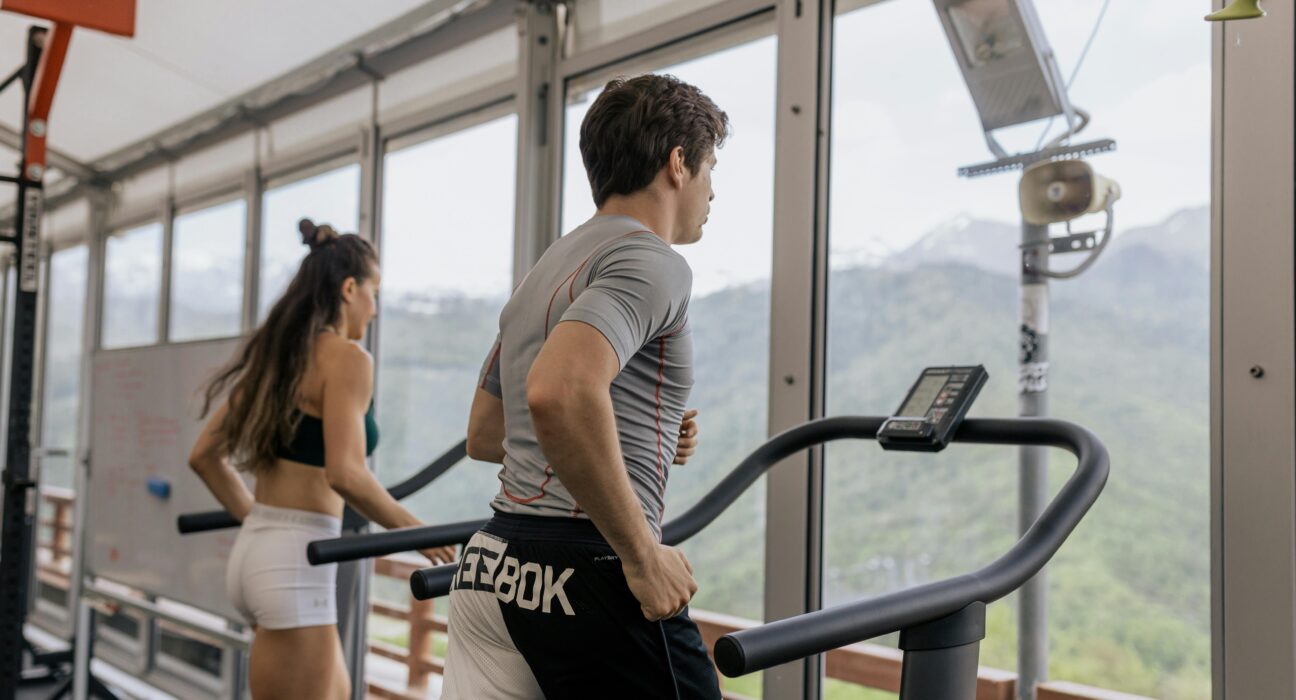 Person doing cardio exercises in gym on treadmill