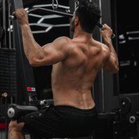 Person performing muscle building exercises at the gym