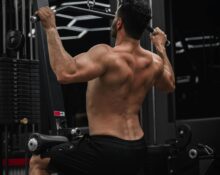 Person performing muscle building exercises at the gym