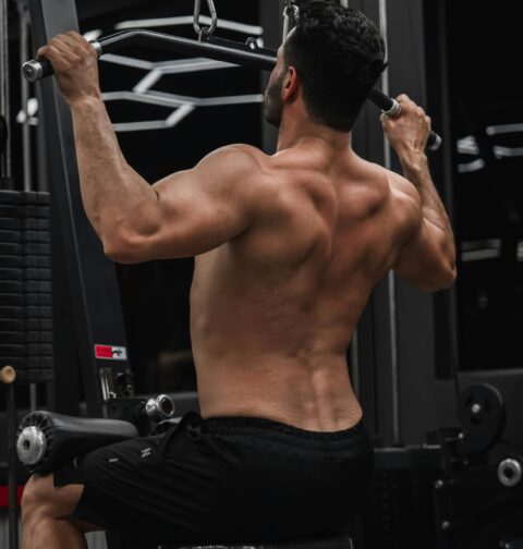 Person performing muscle building exercises at the gym