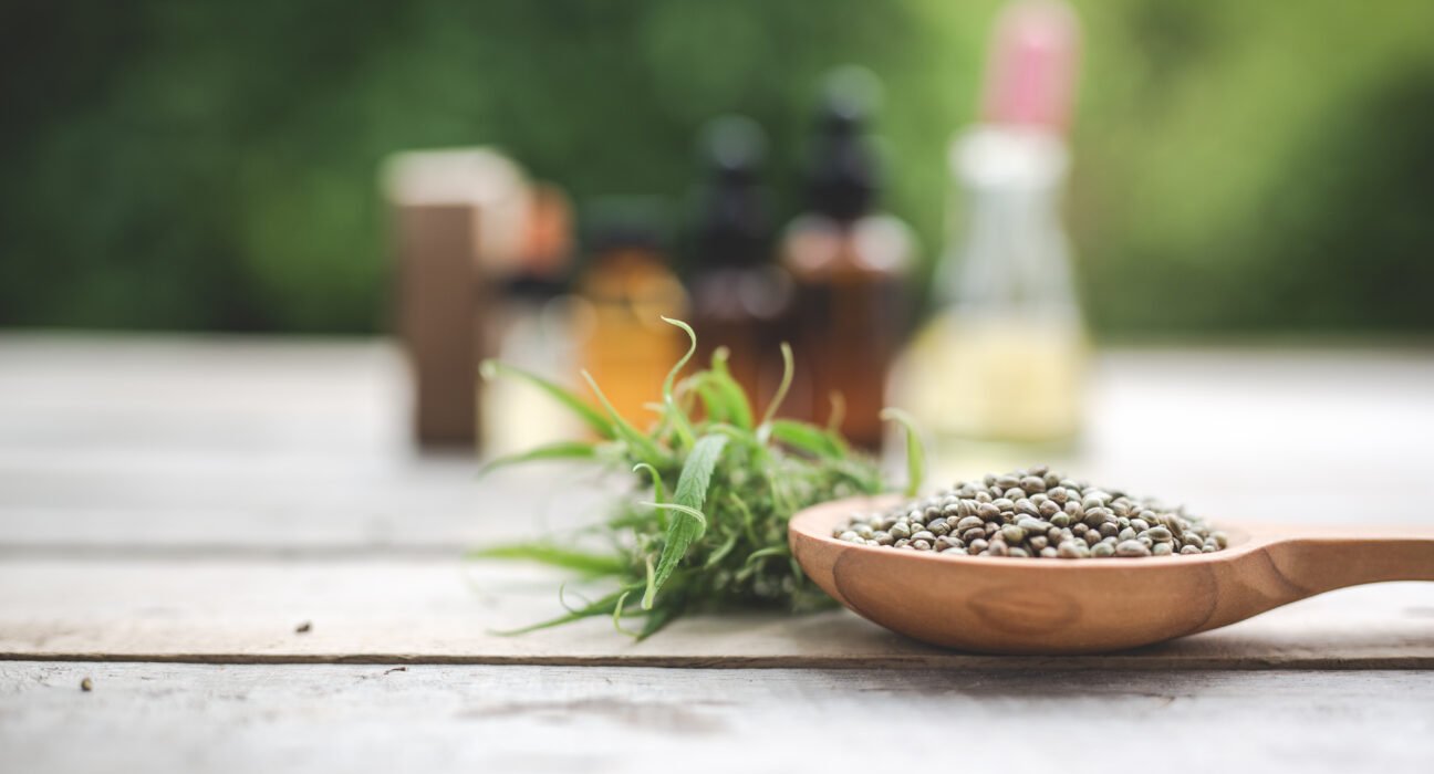 A variety of calming herbal remedies for anxiety including dried chamomile, lavender, and ashwagandha roots on a wooden table