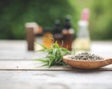 A variety of calming herbal remedies for anxiety including dried chamomile, lavender, and ashwagandha roots on a wooden table