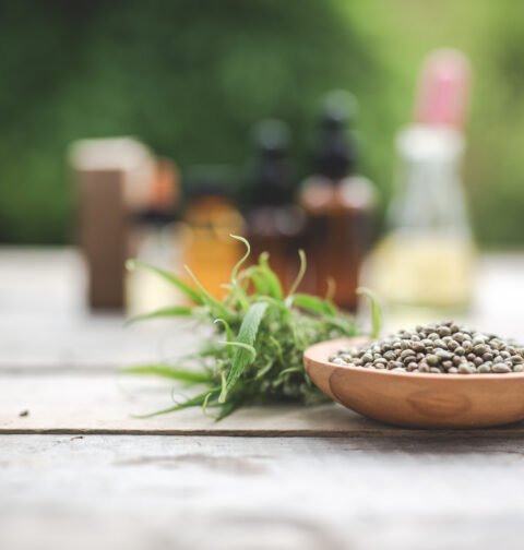A variety of calming herbal remedies for anxiety including dried chamomile, lavender, and ashwagandha roots on a wooden table