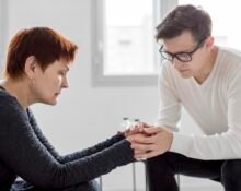 A person practicing daily depression support tips like journaling and drinking herbal tea in a bright room.