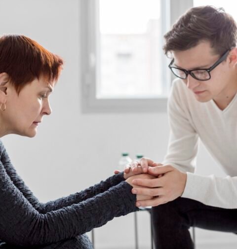 A person practicing daily depression support tips like journaling and drinking herbal tea in a bright room.
