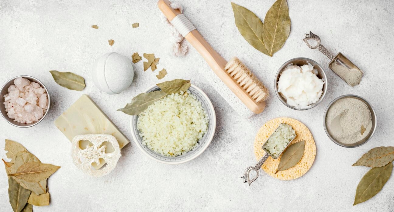 Organic and natural skincare ingredients like aloe vera, honey, and essential oils on a white background