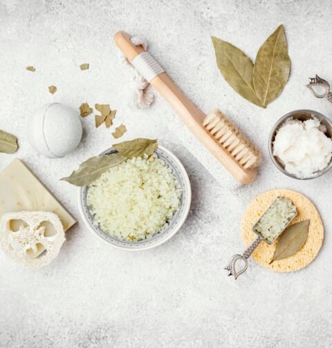 Organic and natural skincare ingredients like aloe vera, honey, and essential oils on a white background