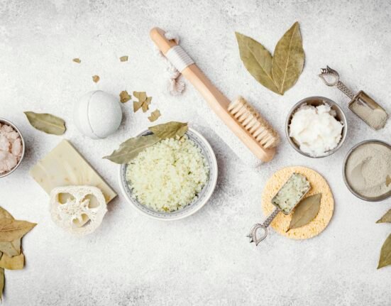 Organic and natural skincare ingredients like aloe vera, honey, and essential oils on a white background