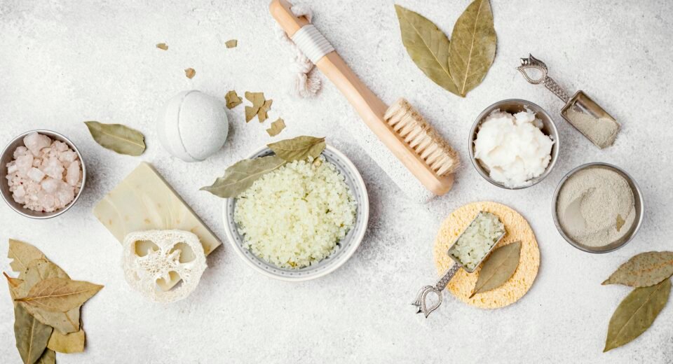 Organic and natural skincare ingredients like aloe vera, honey, and essential oils on a white background