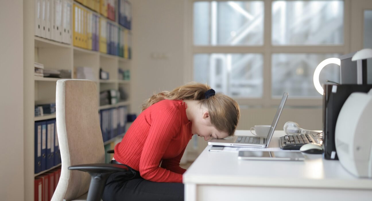 A person practicing effective stress management techniques like deep breathing and herbal tea consumption