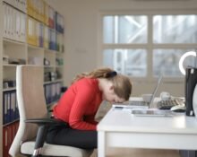 A person practicing effective stress management techniques like deep breathing and herbal tea consumption