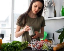 A beautiful flat lay of organic vegetables, reusable bags, and natural skincare representing sustainable organic lifestyle tips