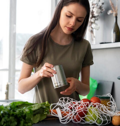 A beautiful flat lay of organic vegetables, reusable bags, and natural skincare representing sustainable organic lifestyle tips