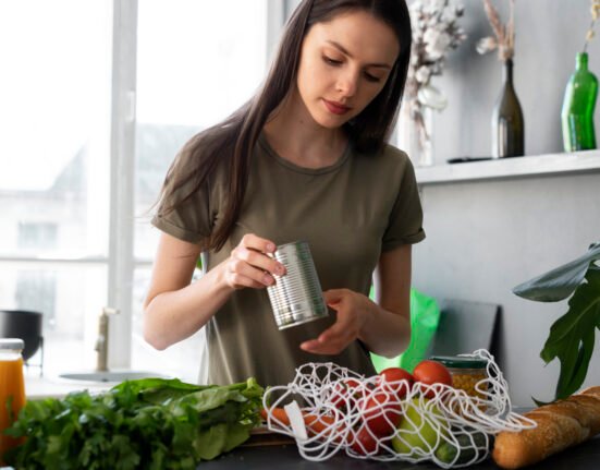 A beautiful flat lay of organic vegetables, reusable bags, and natural skincare representing sustainable organic lifestyle tips